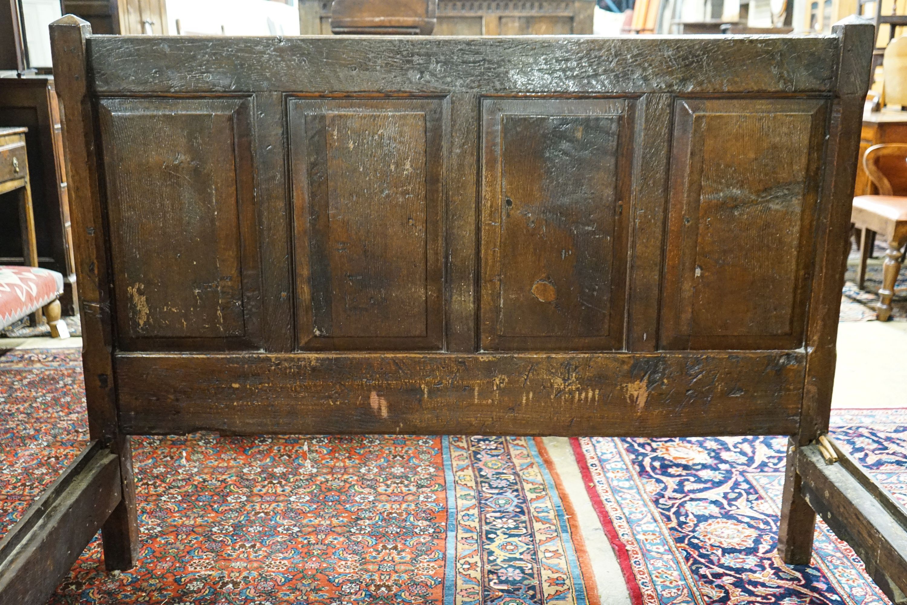 A 17th century style panelled oak bedstead, width 158cm, length 208cm